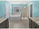The bathroom features a soaking tub, a glass enclosed shower, granite counters, and blue walls at 617 Hiddenbrook Dr, Durham, NC 27703