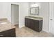Bathroom featuring double vanity with granite countertops and modern fixtures at 617 Hiddenbrook Dr, Durham, NC 27703