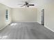 Spacious bedroom with neutral walls and carpet, a ceiling fan, and a window providing natural light at 617 Hiddenbrook Dr, Durham, NC 27703
