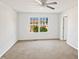 Bright bedroom with neutral carpet and a large window with a view of the neighborhood at 617 Hiddenbrook Dr, Durham, NC 27703
