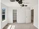 Spacious bedroom with neutral carpet, a ceiling fan, window and a walk-in closet at 617 Hiddenbrook Dr, Durham, NC 27703
