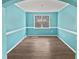 Bright dining room features wood floors, a modern chandelier, and a large window for natural light at 617 Hiddenbrook Dr, Durham, NC 27703