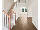 Inviting foyer with hardwood floors, staircase, and arched doorway leading to the rest of the home at 617 Hiddenbrook Dr, Durham, NC 27703