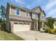 Charming two-story home featuring a spacious two-car garage, inviting front porch, and lush landscaping at 617 Hiddenbrook Dr, Durham, NC 27703