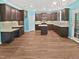 An open-concept kitchen with an island, granite countertops, and ample dark wood cabinetry at 617 Hiddenbrook Dr, Durham, NC 27703