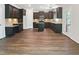 Large kitchen featuring wood floors, dark cabinets, granite countertops, and central island at 617 Hiddenbrook Dr, Durham, NC 27703