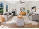Bright living room with a fireplace, large windows, and neutral tones and modern decor at 617 Hiddenbrook Dr, Durham, NC 27703