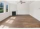 Bright and airy living room featuring a fireplace, new floors, and large windows at 617 Hiddenbrook Dr, Durham, NC 27703