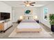Comfortable main bedroom with soft carpet, ceiling fan, and stylish decor at 617 Hiddenbrook Dr, Durham, NC 27703