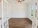 Bright office space with hardwood floors, a ceiling fan, and natural light from the window at 617 Hiddenbrook Dr, Durham, NC 27703