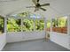 A sunroom enclosed with lots of windows showing trees and a fenced in area at 617 Hiddenbrook Dr, Durham, NC 27703