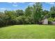 Well-maintained backyard with a storage shed, lush lawn, and mature trees, perfect for outdoor activities at 634 Cotton Brook Dr, Fuquay Varina, NC 27526