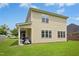 The house has neutral siding, with many windows and a covered patio area overlooking a spacious lawn at 634 Cotton Brook Dr, Fuquay Varina, NC 27526