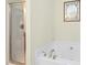 Close-up of bathroom featuring a tub and shower with glass door at 634 Cotton Brook Dr, Fuquay Varina, NC 27526