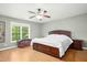 Bedroom featuring a wooden bed frame, light hardwood floors, and a storage chest near the window at 634 Cotton Brook Dr, Fuquay Varina, NC 27526