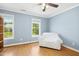 Bedroom featuring two windows and hardwood floors at 634 Cotton Brook Dr, Fuquay Varina, NC 27526
