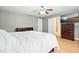 Bedroom featuring light hardwood floors, a mounted TV, and easy access to the ensuite bathroom at 634 Cotton Brook Dr, Fuquay Varina, NC 27526