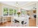 Cozy dining area with natural light, hardwood floors, and seating for four, next to the living room at 634 Cotton Brook Dr, Fuquay Varina, NC 27526