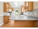Functional kitchen with stainless steel appliances, laminate countertops, tile backsplash, and wood cabinets at 634 Cotton Brook Dr, Fuquay Varina, NC 27526