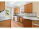 Bright kitchen with laminate countertops, stainless steel sink, tile backsplash, and hardwood floors at 634 Cotton Brook Dr, Fuquay Varina, NC 27526