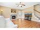 Spacious living room features a fireplace, backyard access, hardwood floors, and access to stairs at 634 Cotton Brook Dr, Fuquay Varina, NC 27526