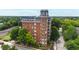 Birds-eye view of a brick building surrounded by lush trees and landscaping at 710 Independence Pl # 103, Raleigh, NC 27603
