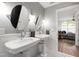 Elegant bathroom with dual vanities, decorative mirrors, and stylish fixtures at 710 Independence Pl # 103, Raleigh, NC 27603