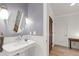 Bright bathroom featuring a pedestal sink, round mirror, and white subway tile at 710 Independence Pl # 103, Raleigh, NC 27603