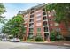 A lovely brick building with balconies is partially obscured by trees at 710 Independence Pl # 103, Raleigh, NC 27603