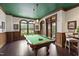 This game room features a pool table, hardwood floors, arched windows and doors at 710 Independence Pl # 103, Raleigh, NC 27603