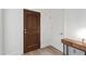 Hallway with dark wood door, white door, and modern table with lamp at 710 Independence Pl # 103, Raleigh, NC 27603