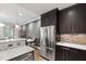 Modern kitchen boasts stainless steel appliances, sleek dark cabinets, and marble countertops at 710 Independence Pl # 103, Raleigh, NC 27603