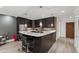 Modern kitchen with dark cabinets, marble countertops, and stainless steel appliances at 710 Independence Pl # 103, Raleigh, NC 27603