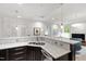Bright kitchen featuring marble countertops, modern fixtures, and an open layout to the living area at 710 Independence Pl # 103, Raleigh, NC 27603