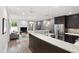 Open-concept living area with modern furnishings and stainless appliances in a gourmet kitchen at 710 Independence Pl # 103, Raleigh, NC 27603