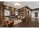 Lobby sitting area with leather chairs, built in bookshelves, and dark wood floors at 710 Independence Pl # 103, Raleigh, NC 27603