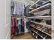 Organized walk-in closet provides ample storage with shelving, hanging space, and shoe racks at 710 Independence Pl # 103, Raleigh, NC 27603