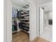 Spacious walk-in closet with custom shelving and rods, leading to a modern bathroom at 710 Independence Pl # 103, Raleigh, NC 27603