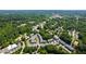 Stunning aerial view showcasing a townhouse complex surrounded by mature trees and lush greenery at 717 Samuel Cary Dr, Cary, NC 27511