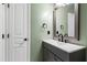 Bathroom with gray vanity, black fixtures, and neutral walls at 717 Samuel Cary Dr, Cary, NC 27511