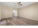 Spacious bedroom features wood-look floors, ceiling fan, and an ensuite bathroom at 717 Samuel Cary Dr, Cary, NC 27511