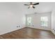 Bedroom featuring luxury vinyl floors, two bright windows, neutral walls, and ceiling fan at 717 Samuel Cary Dr, Cary, NC 27511