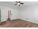 Spacious bedroom featuring luxury vinyl floors, neutral walls, and bright lighting fixture at 717 Samuel Cary Dr, Cary, NC 27511