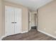 Neutral bedroom features wood-look floors and a closet with double doors at 717 Samuel Cary Dr, Cary, NC 27511