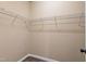Walk-in closet featuring neutral walls, wood-look floors, and wire shelving at 717 Samuel Cary Dr, Cary, NC 27511