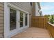 Cozy outdoor deck featuring double doors to interior and wood railings for privacy at 717 Samuel Cary Dr, Cary, NC 27511