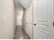 Hallway featuring neutral walls, white trim, wood-look floors, and white doors at 717 Samuel Cary Dr, Cary, NC 27511