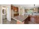 Spacious kitchen featuring an island, dark wood cabinetry, and stainless steel appliances at 717 Samuel Cary Dr, Cary, NC 27511