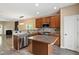Open kitchen layout with island, stainless steel appliances, and adjacent living area at 717 Samuel Cary Dr, Cary, NC 27511