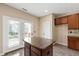 Functional kitchen island, stainless steel appliances, and backyard access at 717 Samuel Cary Dr, Cary, NC 27511
